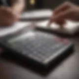 A person calculating finances with a calculator and notebook