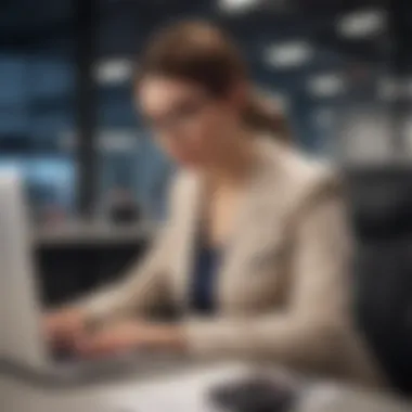 An individual using a laptop to file a compensation claim